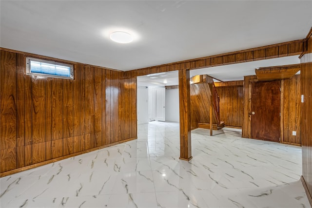 basement featuring wooden walls