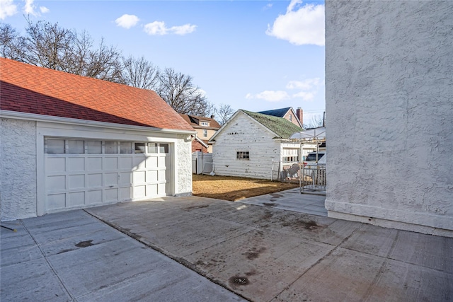 exterior space with a garage and an outdoor structure