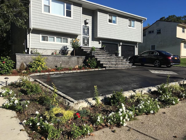 bi-level home featuring driveway and an attached garage