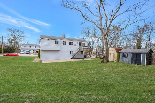 15 Bart Dr, Selden, NY 11784 - back of house featuring an outdoor structure, a yard, stairway, a wooden deck, and a storage unit
