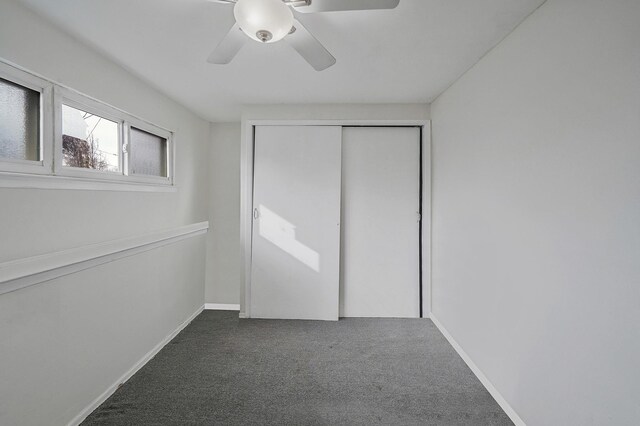 15 Bart Dr, Selden, NY 11784 - unfurnished bedroom featuring a ceiling fan, baseboards, dark colored carpet, and a closet