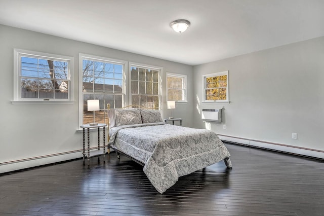 bedroom with a baseboard radiator, a wall unit AC, and dark hardwood / wood-style floors