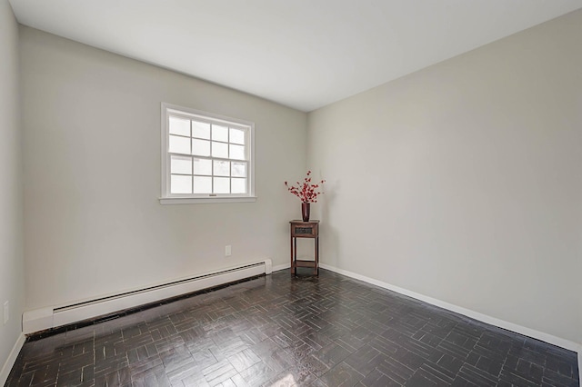 empty room with dark parquet floors and baseboard heating