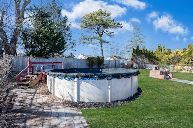 view of pool with a yard