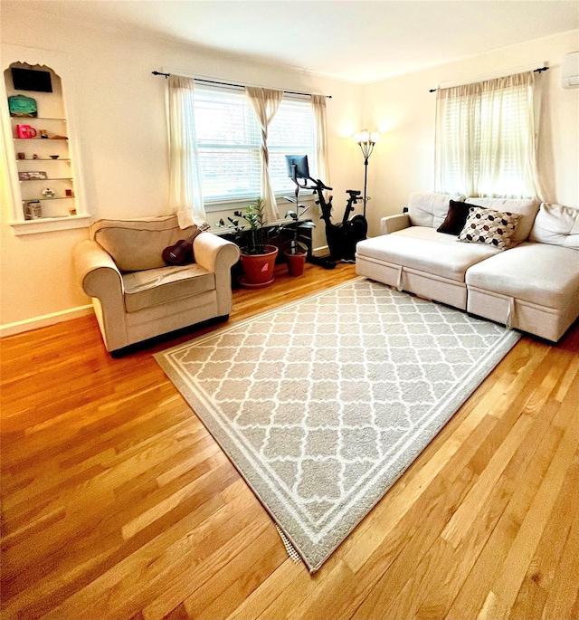 living area featuring baseboards and wood finished floors