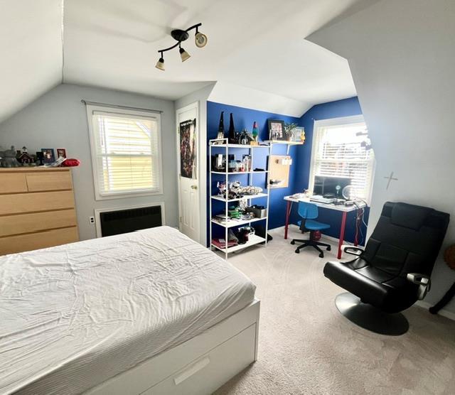 bedroom with carpet flooring and lofted ceiling