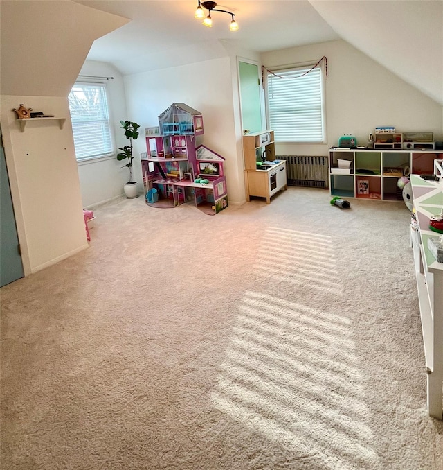 game room with radiator, carpet, and lofted ceiling