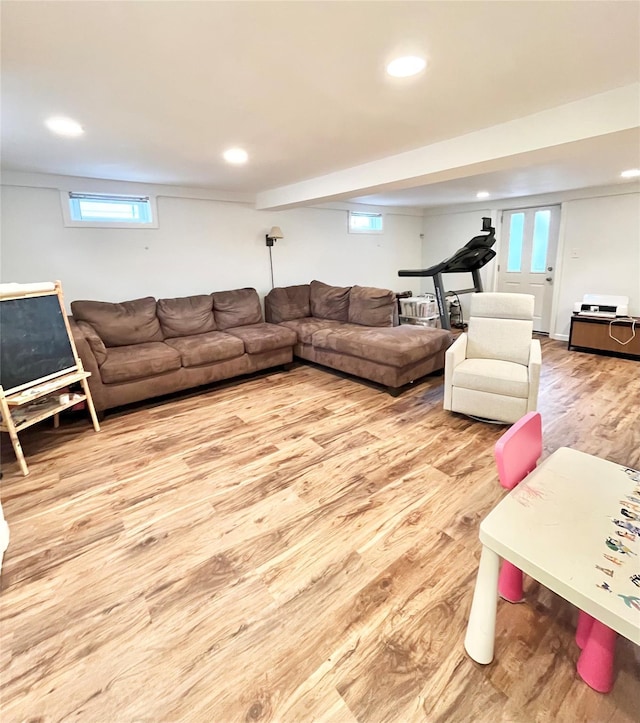 living area with recessed lighting, plenty of natural light, and wood finished floors