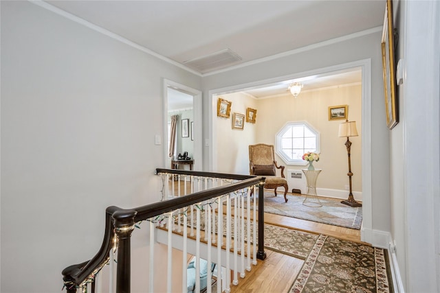 hallway featuring hardwood / wood-style flooring and ornamental molding