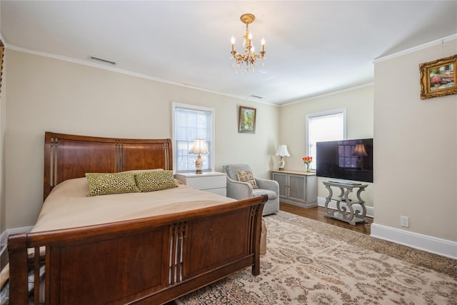 bedroom with ornamental molding and a chandelier