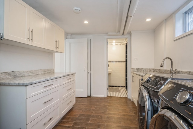 laundry area with cabinets, separate washer and dryer, and dark hardwood / wood-style floors