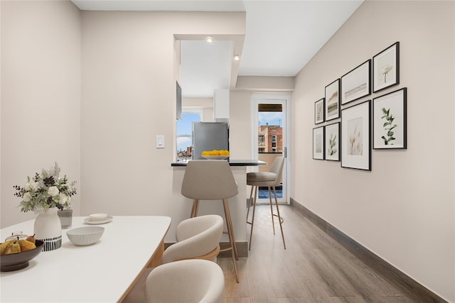 dining area featuring baseboards and wood finished floors