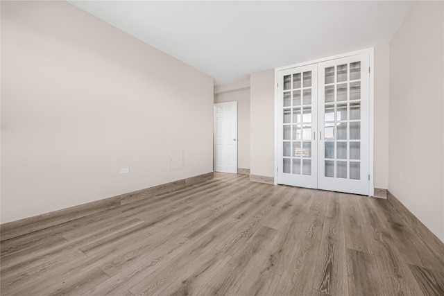 unfurnished room featuring french doors and wood finished floors