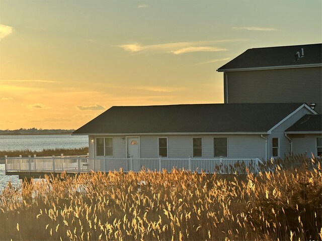 property exterior at dusk with a water view