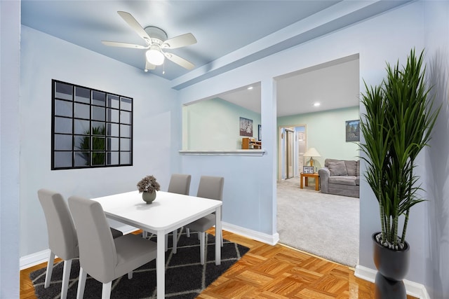 dining area with ceiling fan and light parquet floors