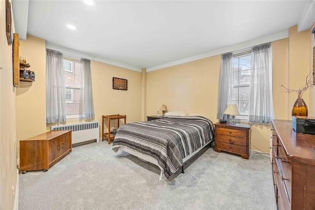 carpeted bedroom featuring radiator heating unit and ornamental molding