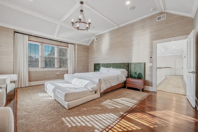 bedroom with lofted ceiling, wallpapered walls, a notable chandelier, and wood finished floors