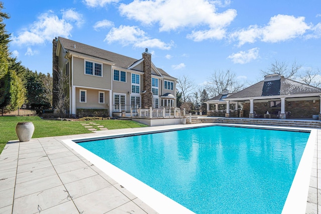 outdoor pool with a yard, a patio, and a gazebo