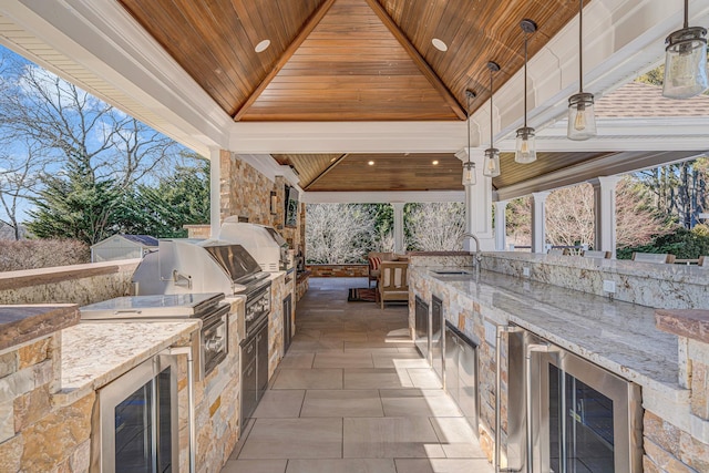 view of patio featuring grilling area, a gazebo, a sink, exterior kitchen, and beverage cooler