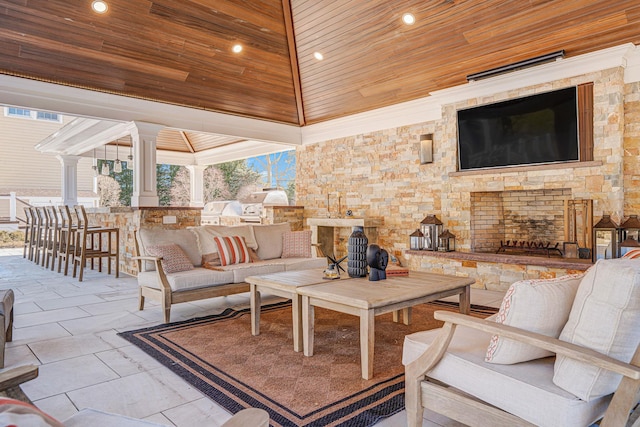 view of patio featuring an outdoor living space with a fireplace, a grill, and a gazebo