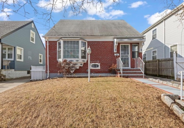 bungalow-style house featuring a front yard