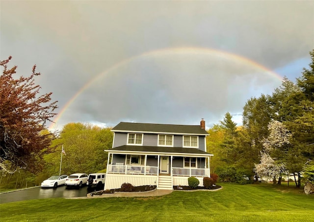 view of front of home with a front yard and a porch