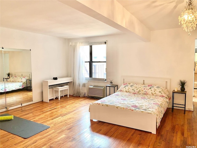 bedroom featuring hardwood / wood-style floors and a chandelier