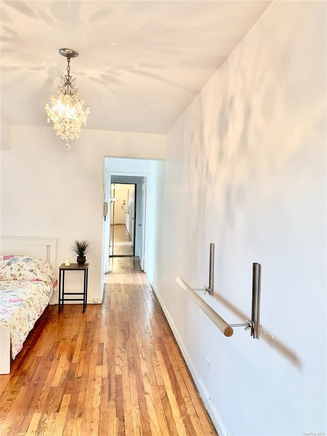 interior space with a notable chandelier and wood-type flooring