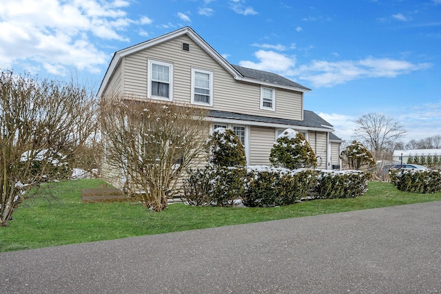 view of home's exterior with a lawn