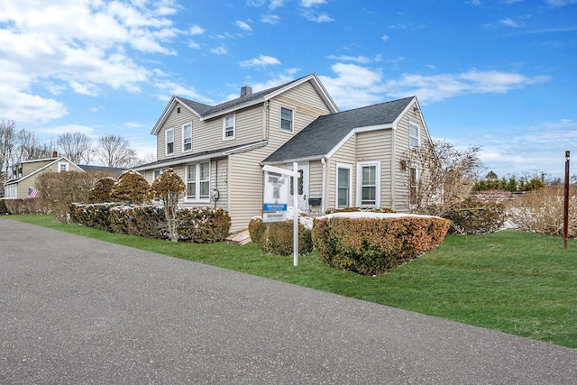 view of side of home with a yard