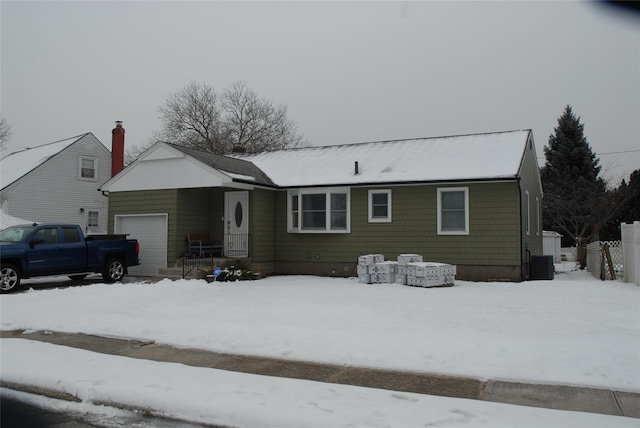 view of front facade featuring a garage and central AC