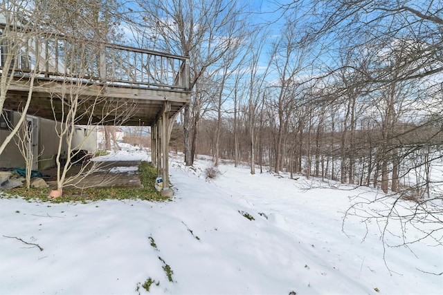 yard layered in snow featuring a wooden deck