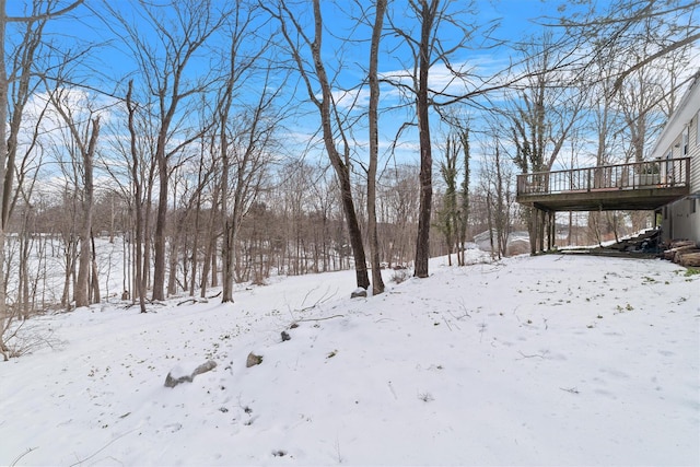 snowy yard with a deck