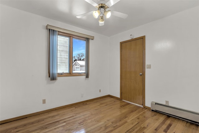 unfurnished room with ceiling fan, light wood-type flooring, and baseboard heating