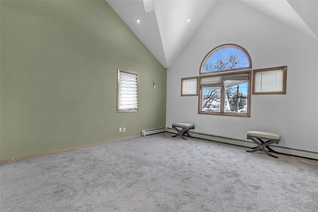 carpeted spare room featuring high vaulted ceiling