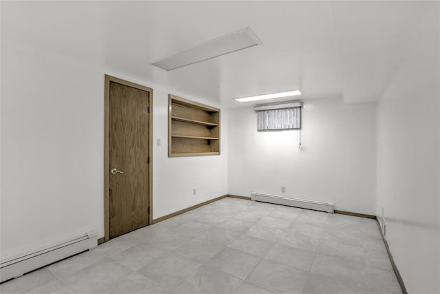 spare room featuring baseboard heating and built in features