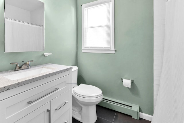 bathroom featuring vanity, baseboards, a baseboard radiator, tile patterned flooring, and toilet