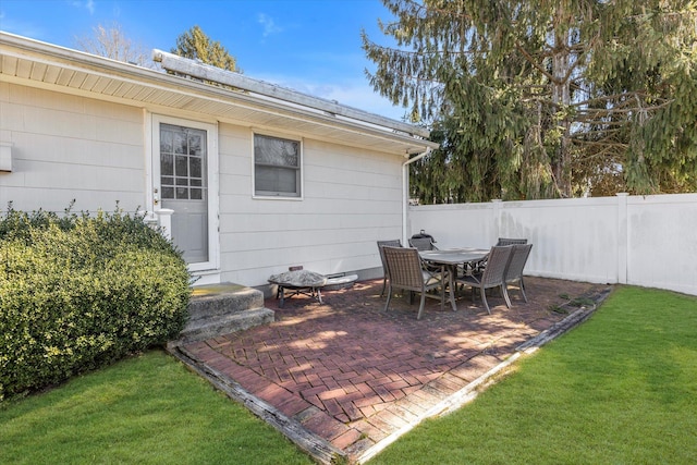 view of patio featuring outdoor dining space and fence