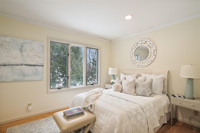 bedroom with hardwood / wood-style flooring and ornamental molding