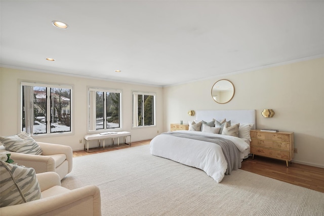 bedroom featuring recessed lighting, baseboards, ornamental molding, and wood finished floors