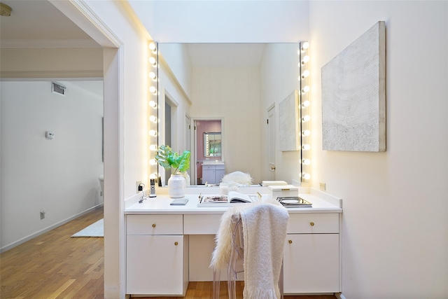 bathroom with visible vents, vanity, and wood finished floors