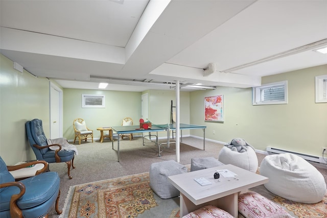 recreation room featuring a baseboard heating unit, baseboards, and carpet floors