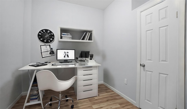 home office with light hardwood / wood-style floors