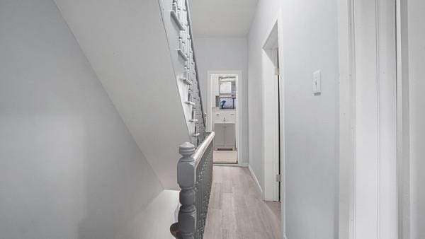 corridor with light hardwood / wood-style floors