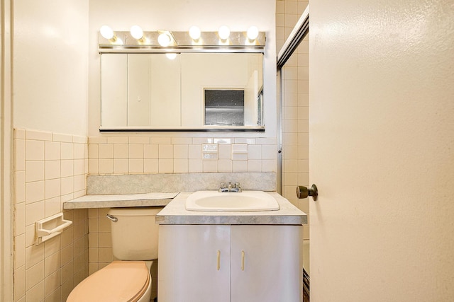 70-25 Yellowstone Blvd Unit 18A, Forest Hills, NY 11375 - bathroom featuring toilet, vanity, tile walls, and decorative backsplash