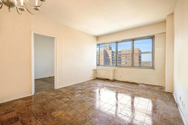 70-25 Yellowstone Blvd Unit 18A, Forest Hills, NY 11375 - spare room with a chandelier, a city view, baseboards, and radiator heating unit