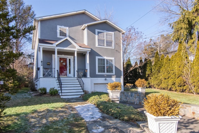 view of front of property featuring a garage and a front yard