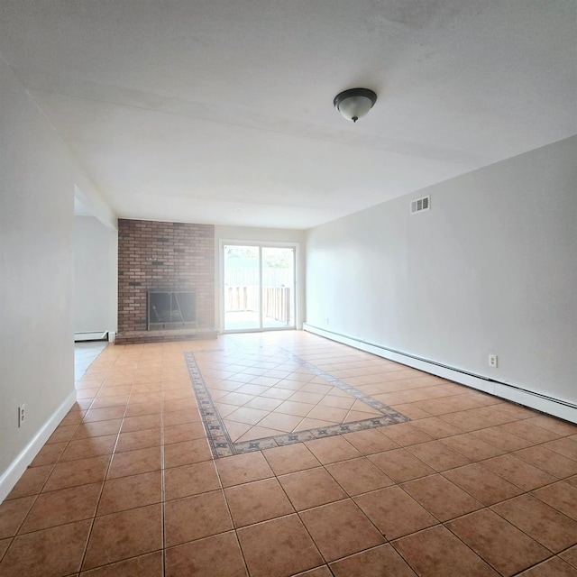 unfurnished living room featuring a brick fireplace, a baseboard heating unit, and light tile patterned floors