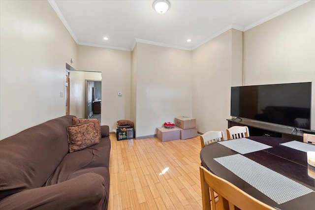 living room with ornamental molding and light wood-type flooring