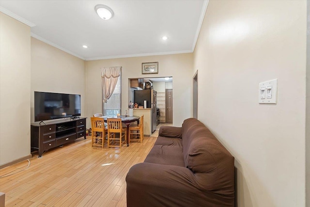 living room featuring light hardwood / wood-style flooring and ornamental molding